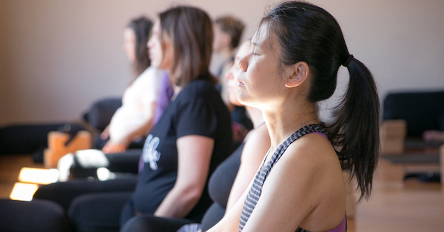 A photo of pregnant yoga students meditating on their deepest question at MamaSpace Yoga