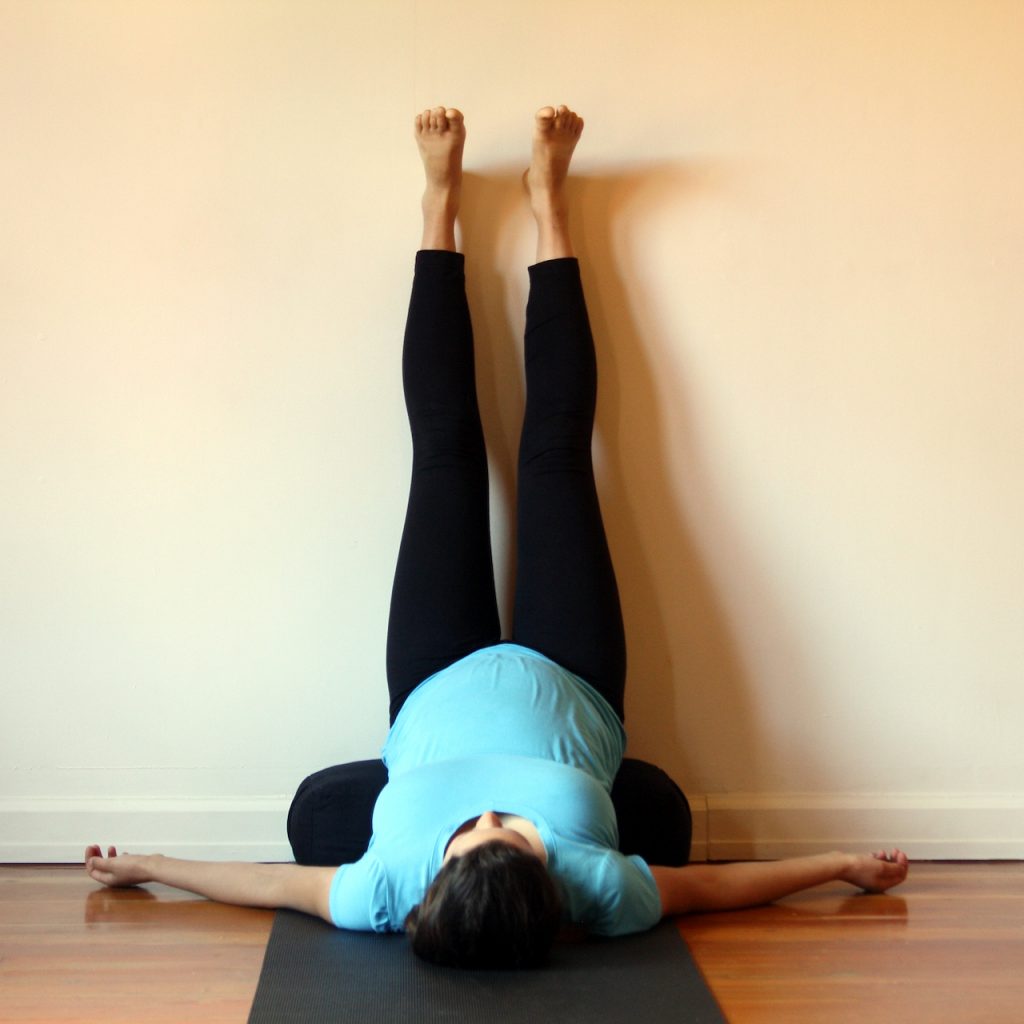 A pregnant student demonstrating Legs Up The Wall at MamaSpace Yoga