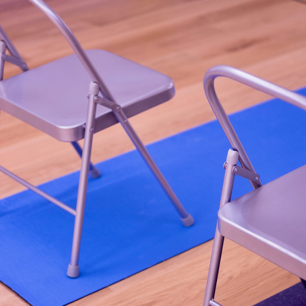 A photo of special folding chairs and a yoga mat used to enhance youryoga practice at MamaSpace Yoga