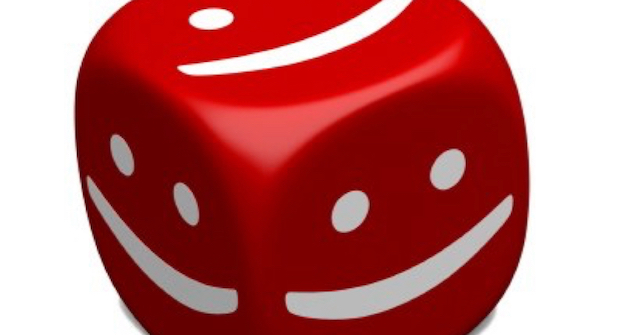 A picture of a red die with white smiley faces on all sides depicting flat spots on baby heads