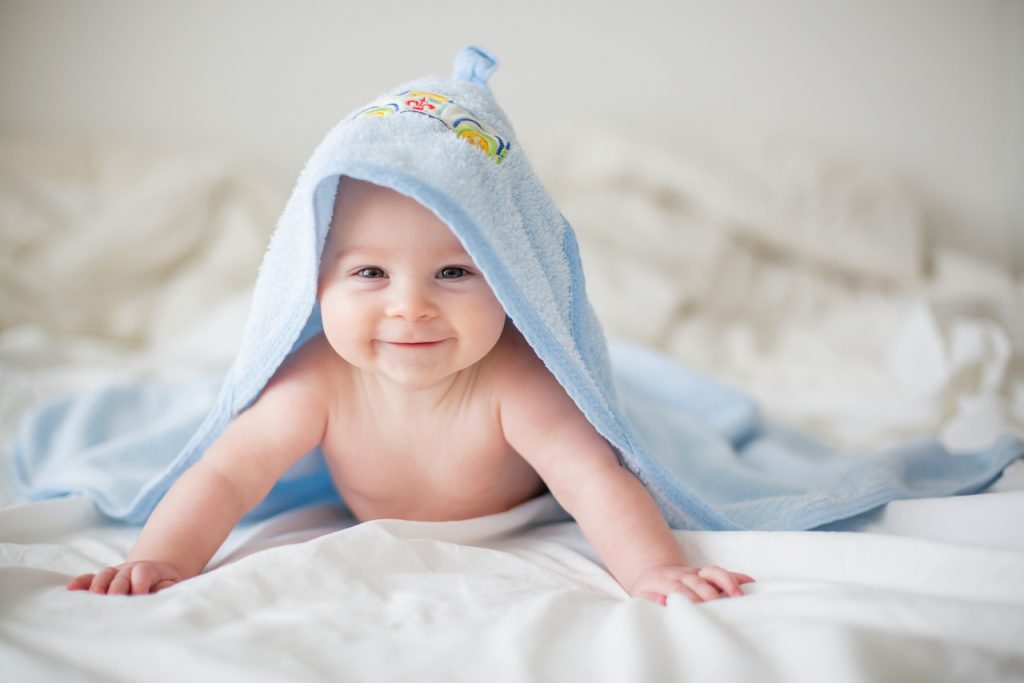 A baby smiling in tummy time