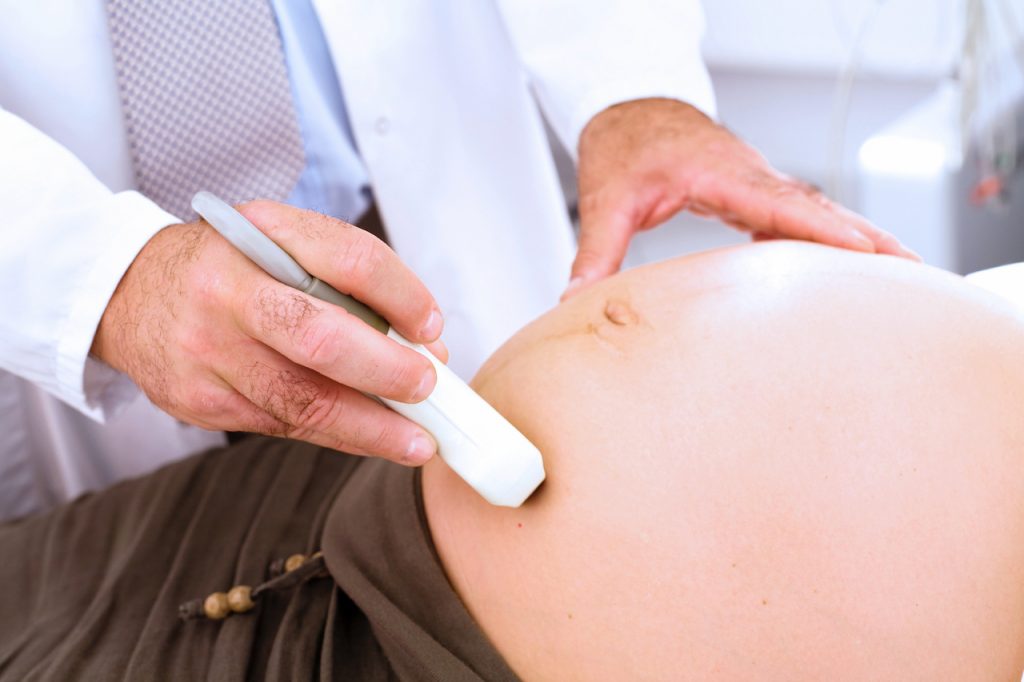 A photo of a technician performing an obstetrical ultrasound