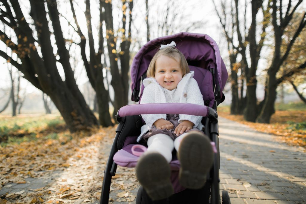 A photo of a big child in a Stroller