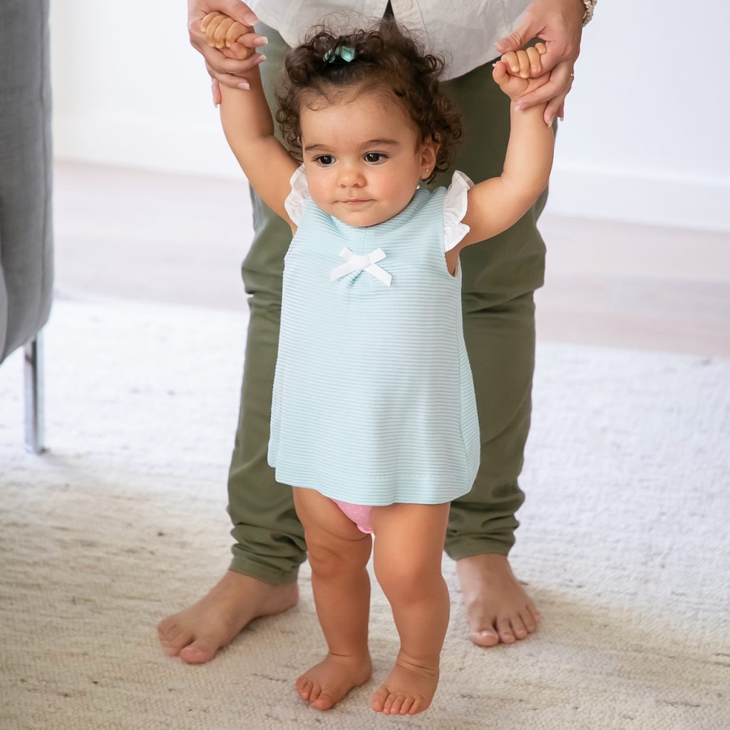 Photo of an adult walking a baby