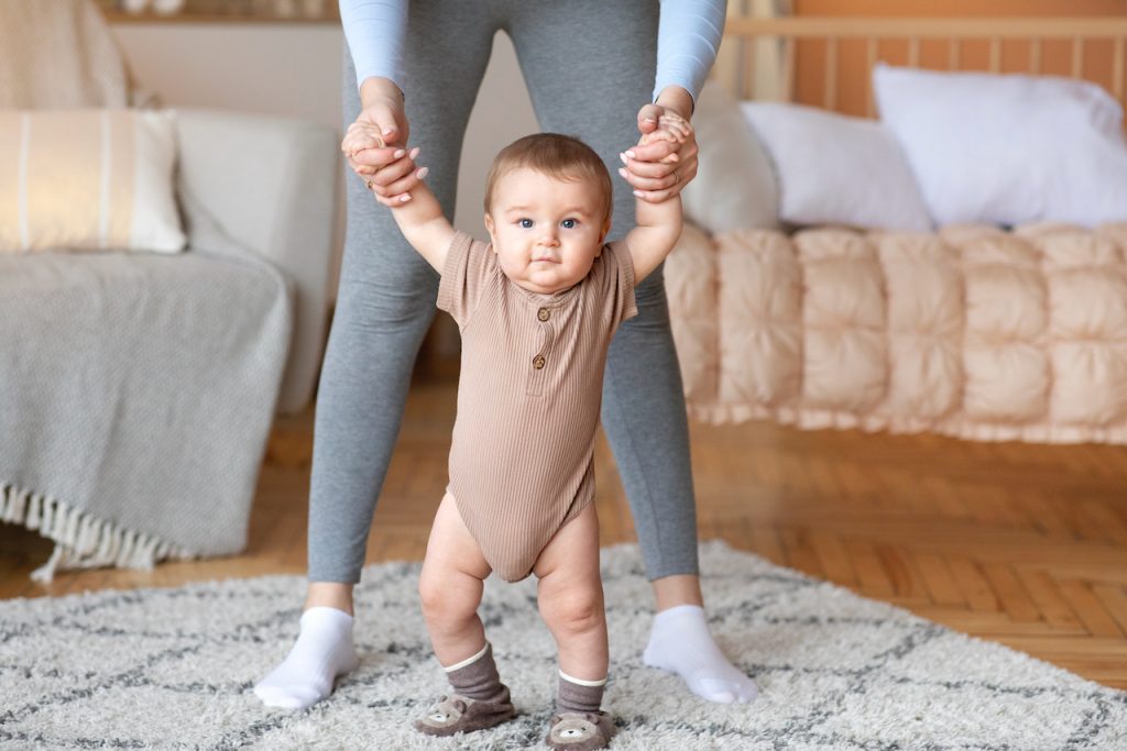 Photo of an adult walking a baby