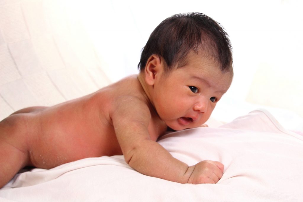 Photo of a baby in tummy time - prone position