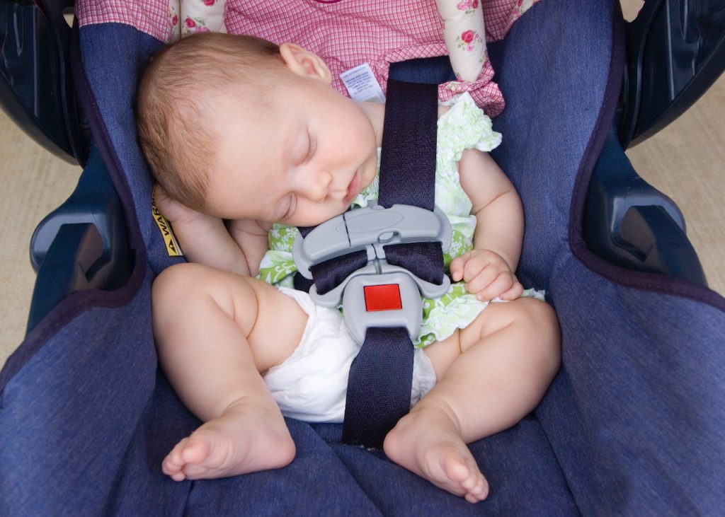A photo of a baby asleep in a Car Seat