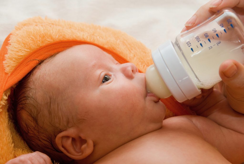 A photo of a baby Bottle Nursing 